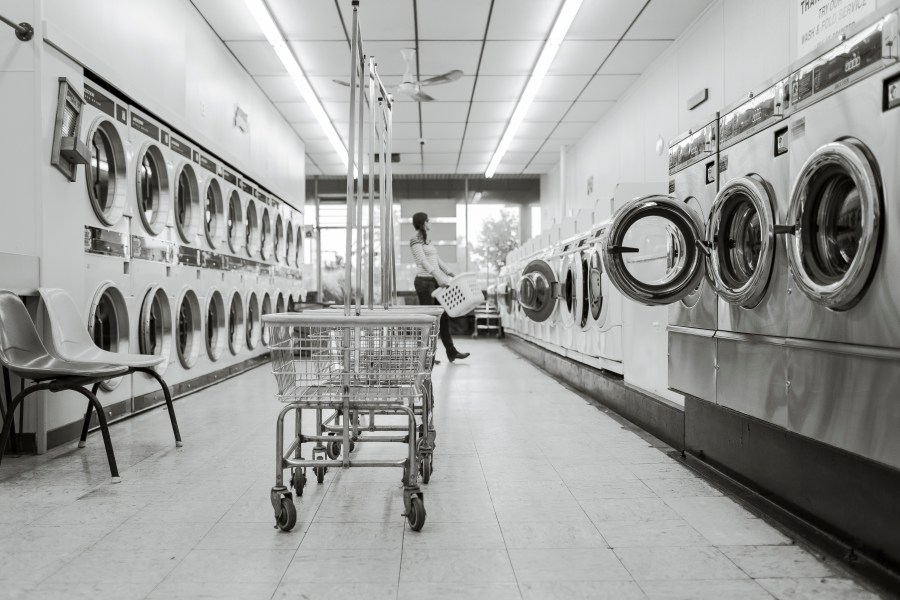 This image has an empty alt attribute; its file name is canva-grayscale-photography-of-woman-in-laundry-shop.jpg